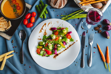 vegetable salad, on the table bread, vegetables, drink, spoon and fork