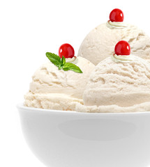 Vanilla ice cream scoops with maraschino cherry  in bowl isolated on white background