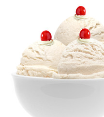 Vanilla ice cream scoops with maraschino cherry  in bowl isolated on white background