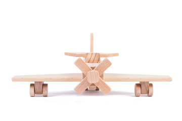 Photo of a wooden plane  of beech. Toy made of wood retro aircraft on a white isolated background