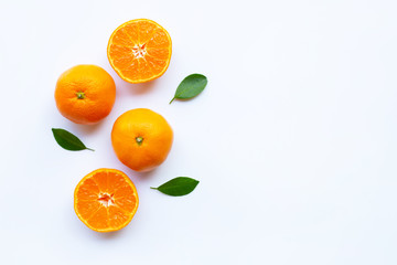 Fototapeta na wymiar Orange citrus fruit with green leaves on white.