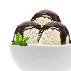 Vanilla ice cream scoops with chocolate syrup, sauce or sherbet in bowl isolated on white background