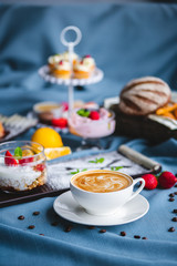 breakfast with coffee, cereal, croissant, yogurt, bread, biscuits