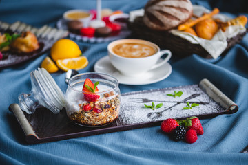 breakfast with coffee, cereal, croissant, yogurt, bread, biscuits