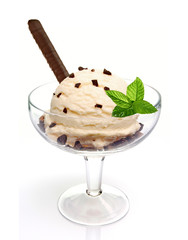 Vanilla ice cream scoop with wafer stick, chocolate chips in glass bowl isolated on white background