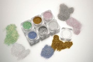 Different colored glitters in transparent jars 