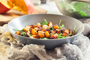 Roasted pumpkin salad with spinach and nuts