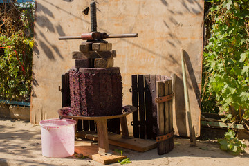 Wine-making. Technology of wine production. The folk tradition of making wine. Wine production in Moldova. The ancient tradition of grape processing. The squeezer is used to press the wine. 