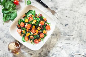 Roasted pumpkin salad with spinach, tomatoes and nuts