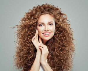 Young happy redhead woman with long healthy curly hair. Hair care concept.