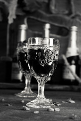 Glass Of Red Wine On The Table With Wine Bottles In The Background