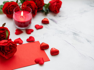 Fototapeta na wymiar Valentines day romantic background - red roses, candle and hearts