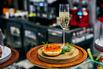 Obraz na płótnie Canvas Glass bowl with red caviar and fresh baked homemade healthy bread on Healthy food
