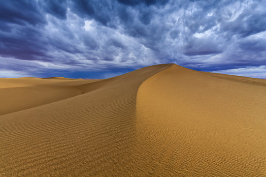 Cloudy sky over sand dunes in the desert © Anton Petrus
