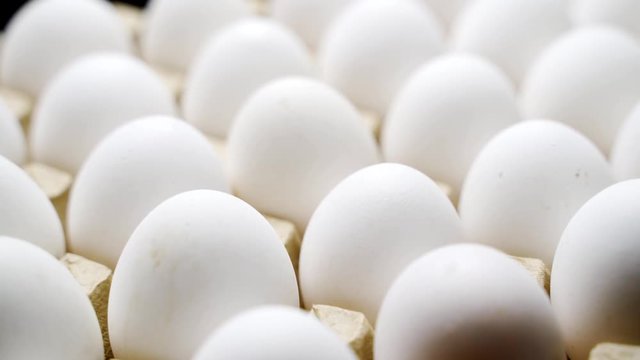 White chicken eggs in a cardboard box. Eggs in a paper tray.