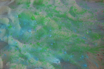 Fototapeta na wymiar Closeup shot of sand texture covered colorful Holi powder. Empty space