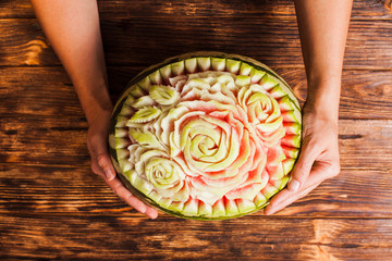 Carved watermelon fruit, top view on the table
