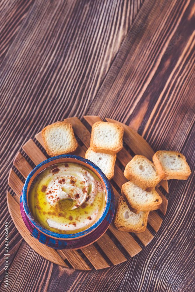 Poster bowl of hummus with toasts