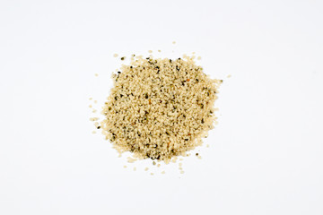 Organic hulled hemp seeds on a white background