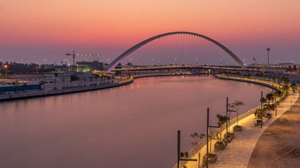 Fototapeta na wymiar View of the Tolerance Bridge and the Dubai Water Canal during Sunset. 