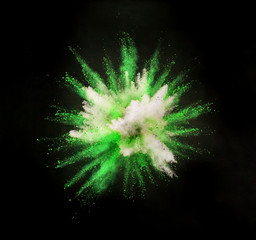 Colored powder explosion on black background. Freeze motion.