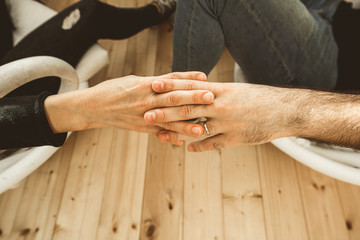 Obraz premium Close-up of two hands fondly joined together. Concept of love between couple