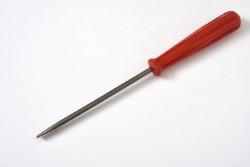 Old screwdriver on white background, shallow focus.