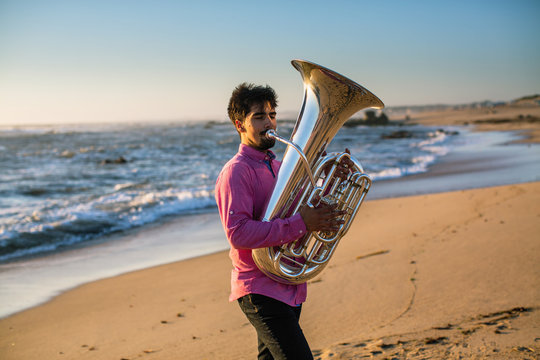 Musician play to tuba on the Sea shore.