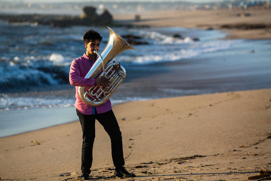 Musician play to tuba on the Sea shore.