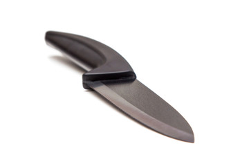 Black knife with ceramic blade on white background