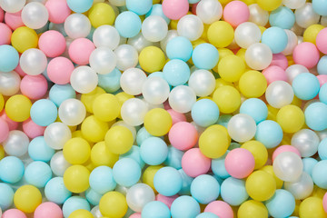 Fototapeta na wymiar Colorful child balls. Multi-colored plastic balls. Achildren's playroom. Background texture of multi-colored plastic balls on playground