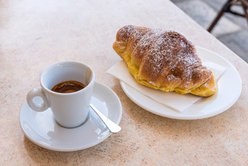 Coffee and croissant with dark chocolate