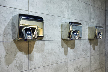 Air Dryer In Public Toilet or Washrooms. selective focus Health and Safety Background Concept