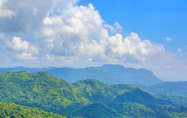 Fototapeta na wymiar Beautiful mountain landscape with mountain forest and blue sky in Thailand.