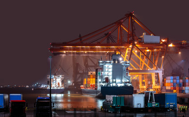 Container ship in port at container terminal in night. Gdynia, Poland