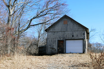 Old rustic weathered wooden barn abandoned in New England Village