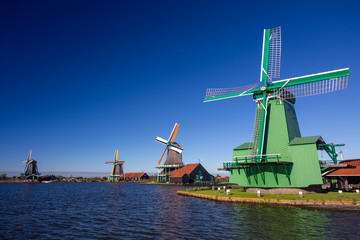 Fototapeta na wymiar Close view on Windmills. Zaanse Schans Windmills and famous Netherlands canals, Europe.