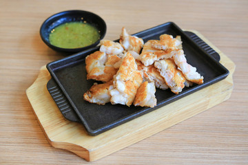 Seafood Teppanyaki squid egg on hot plate served with spicy sauce.