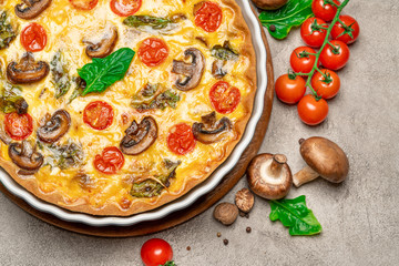 Baked homemade quiche pie in ceramic baking form