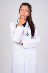 Young beautiful woman doctor thinking while looking up