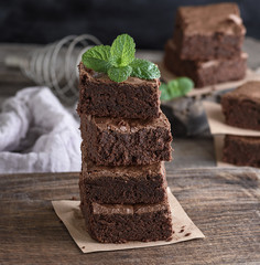 stack of square pieces of baked brown brownie pie