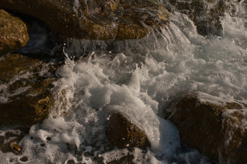 Waves during a storm. View from above. Red code. Rest on the Black Sea coast in Bulgaria. Elemental force. Waves crashing against rocks.