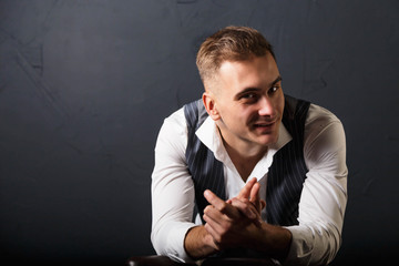 Portrait of young handsome man wearing white shirt standing on the gray background and smiling