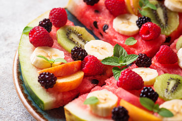 Watermelon pizza with fruit and berries