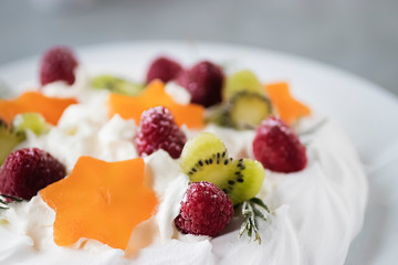 Dessert Pavlova. Cake with whipped cream and fresh berries.