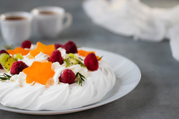 Dessert Pavlova. Cake with whipped cream and fresh berries.