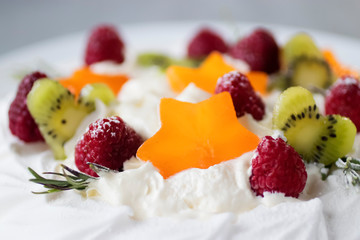 Dessert Pavlova. Cake with whipped cream and fresh berries.