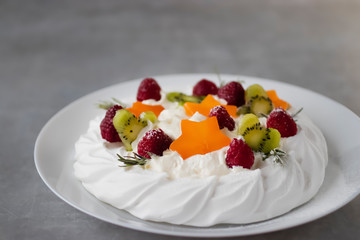 Dessert Pavlova. Cake with whipped cream and fresh berries.