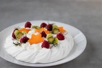 Dessert Pavlova. Cake with whipped cream and fresh berries.