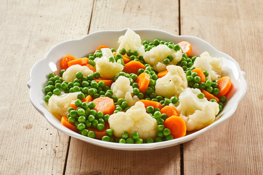 White dish of assorted steamed fresh vegetables